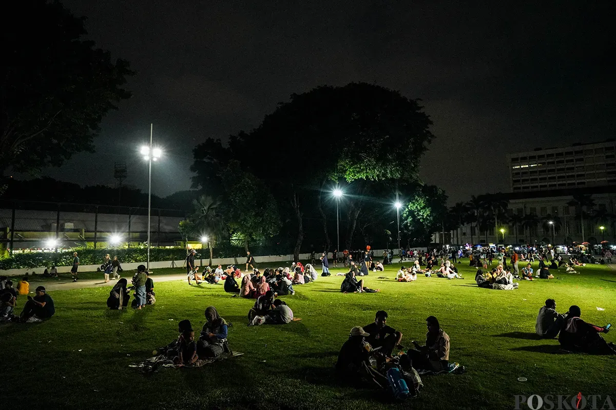 Sejumlah warga menikmati sejumlah fasilitas yang ada di Taman Lapangan Banteng, Jakarta, Minggu, 18 Mei 2025 (malam). (Sumber: Poskota/Bilal Nugraha Ginanjar)