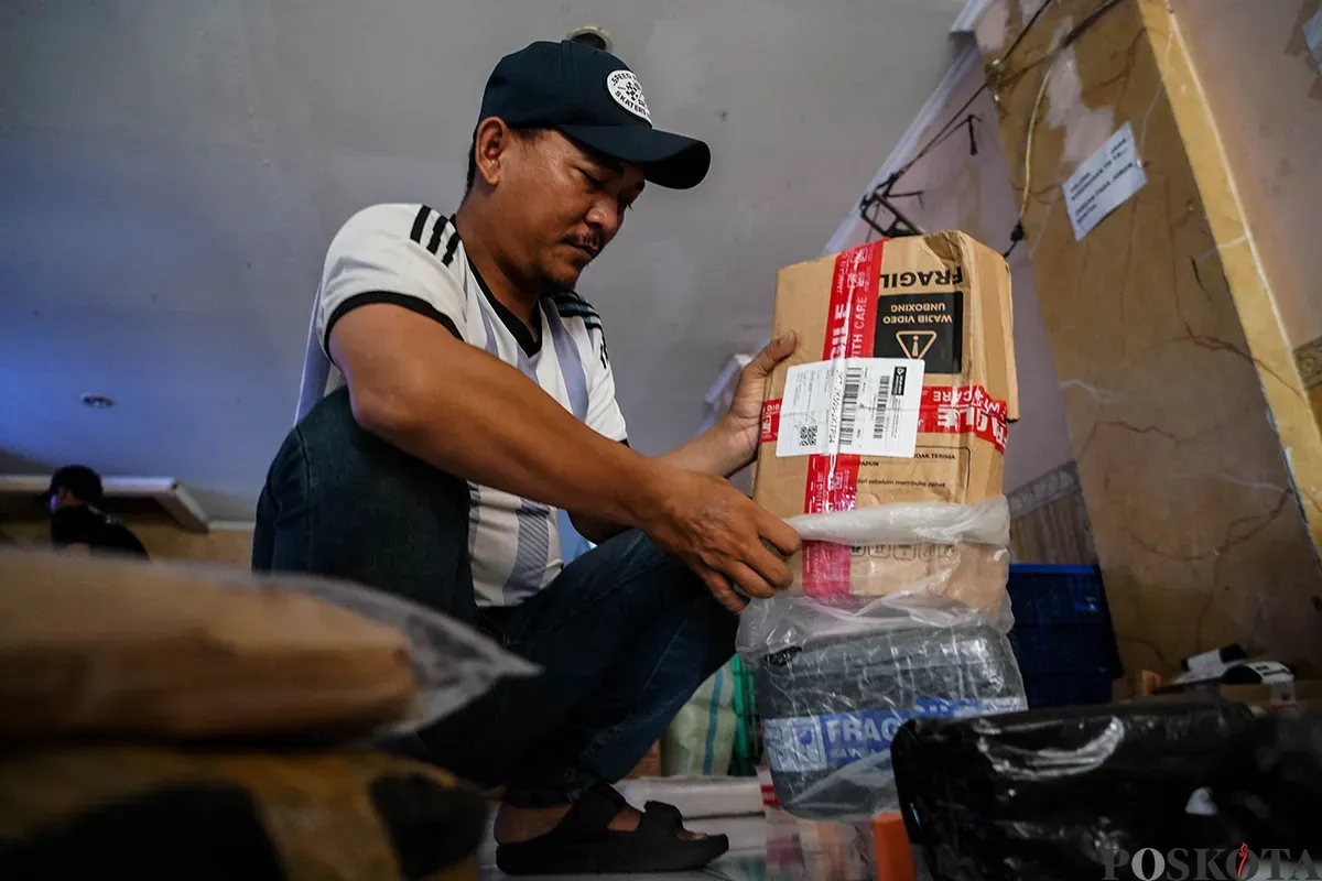 Sejumlah petugas kurir menyortir paket barang di gudang jasa pelayanan pengiriman barang di kawasan Tanjung Priok, Jakarta, Senin, 19 Mei 2025. (Sumber: Poskota/Bilal Nugraha Ginanjar)