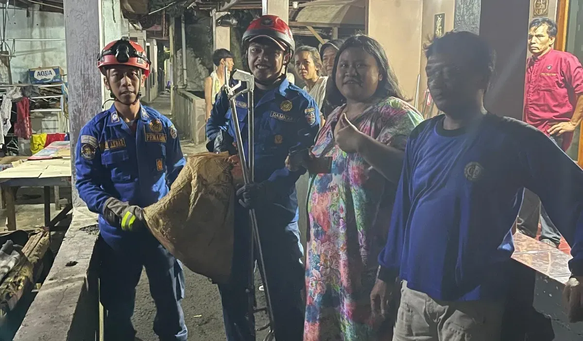 Petugas Damkar Kota Depok amankan ular sanca kembang sepanjang 4 meter berkeliaran dini hari di pemukiman padat penduduk, di Limo Kota Depok, Rabu Dini Hari, 21 Mei 21 Mei 2025. (Sumber: Damkar Depok)