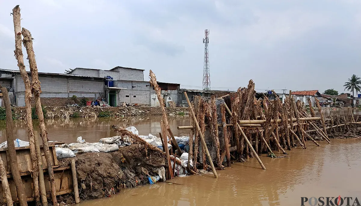 Kondisi Tanggul Kali Srengseng di Desa Sukamanah, Kecamatan Sukatani, Kabupaten Bekasi, tampak lebih surut debit airnya usai jebol pada Sabtu, 1 November 2025. (Sumber: POSKOTA | Foto: Nurpini Aulia Rapika)