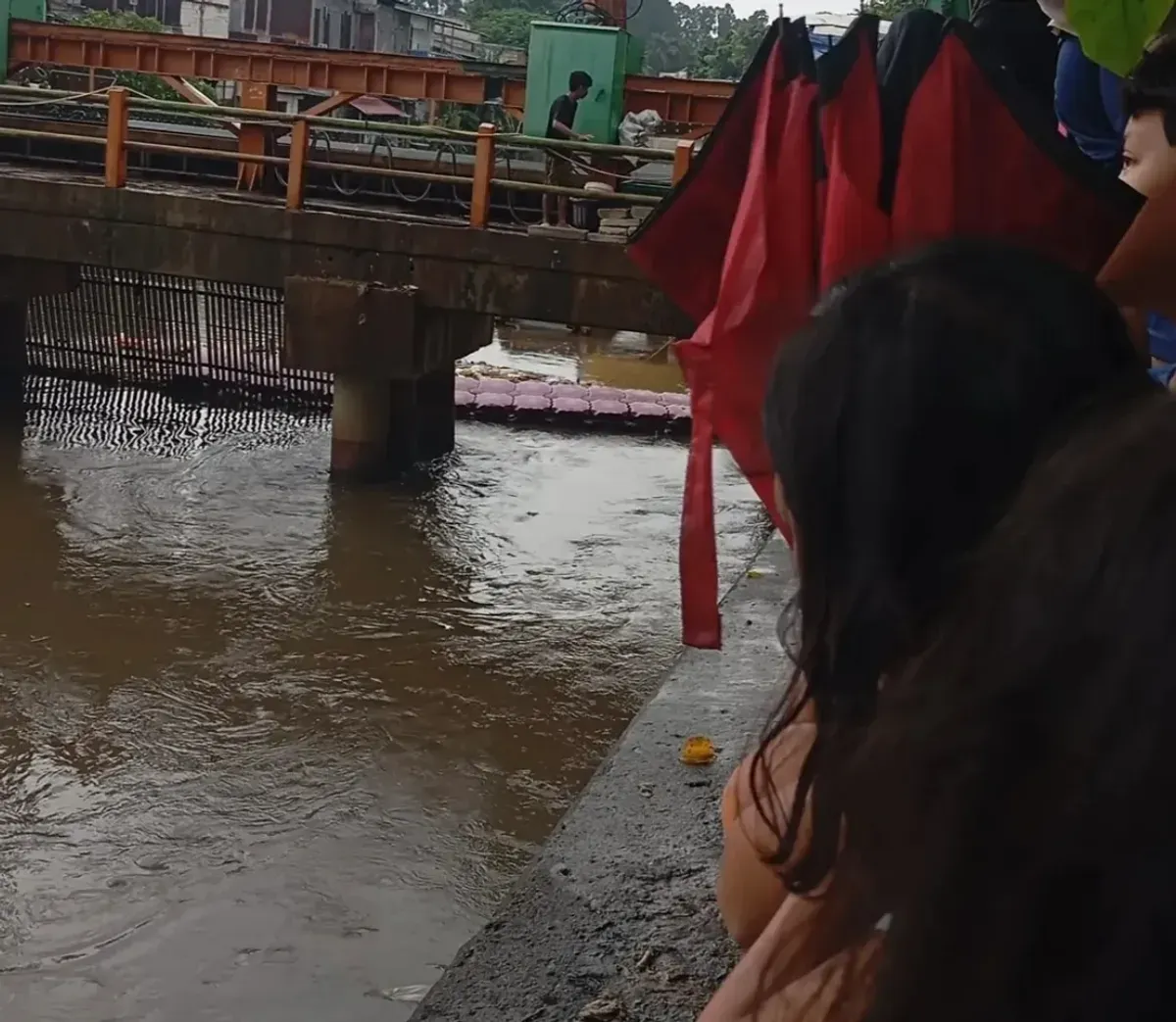 Warga menyaksikan evakuasi mayat pria yang diduga hanyut di aliran Kali Pesanggrahan wilayah Kembangan, Jakarta Barat, Sabtu, 8 November 2025. (Sumber: Istimewa)
