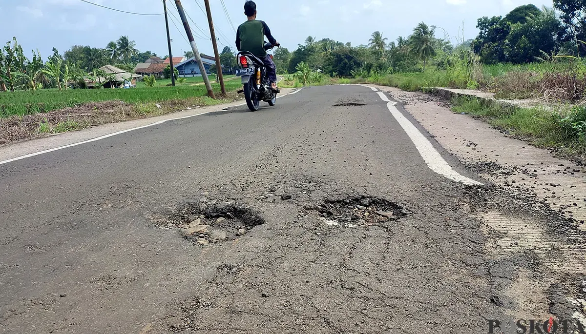 Pengendara roda dua melintas di jalan Babakan Sompok-Kadumadang di Cimanuk, Pandeglang, yang kondisinya rusak lagi. (Sumber: POSKOTA | Foto: Samsul Fatoni)