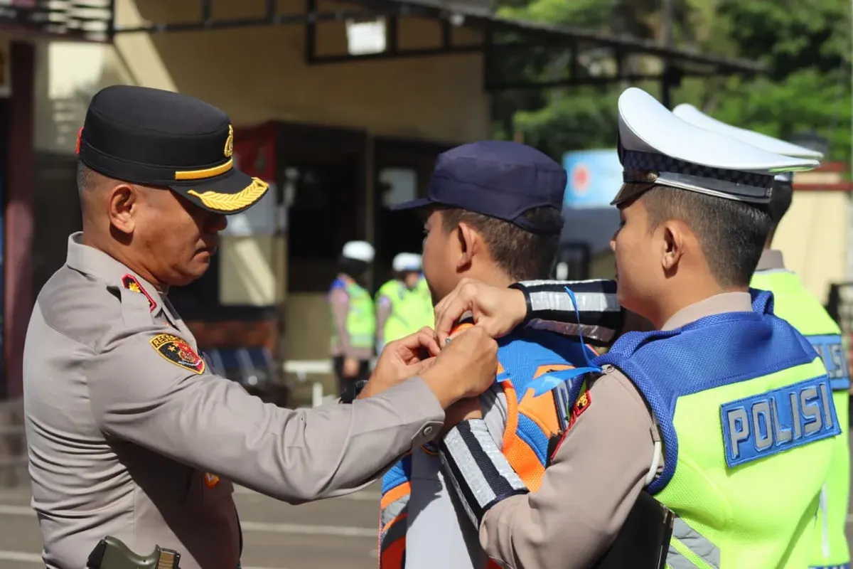 Wakapolres Metro Depok AKBP Akmal menyematkan pin ke masing-masing perwakilan personil di Apel Pasukan Operasi Zebra Jaya 2025 di Lapangan Mapolrestro Depok. (Sumber: Istimewa)