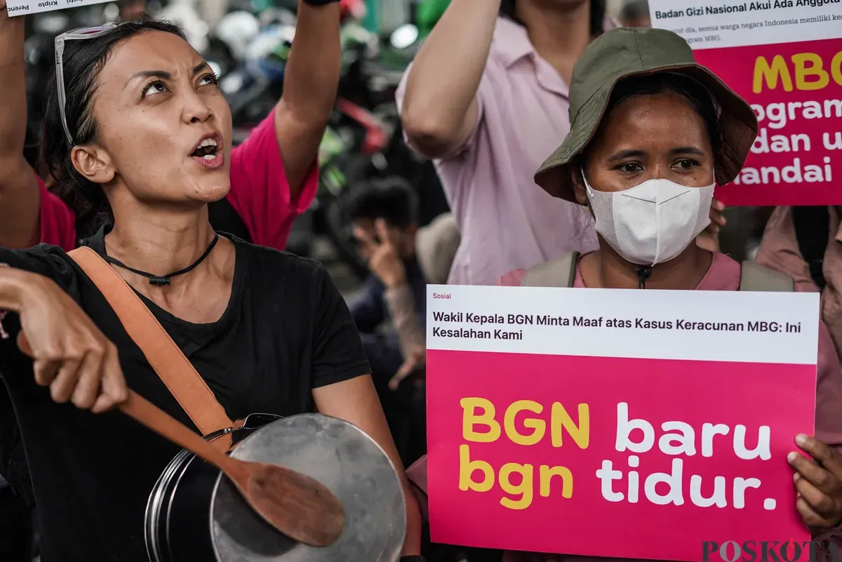 Ibu-ibu membentangkan poster berisi tuntutan evaluasi program Makan Bergizi Gratis di Jalan Medan Merdeka Selatan, Jakarta, Rabu, 1 Oktober 2025. (Sumber: Poskota/Bilal Nugraha Ginanjar)