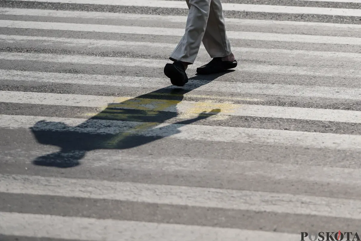 Warga menyeberang jalan saat panas terik matahari di Jalan Jenderal Sudirman, Jakarta Pusat, Kamis, 16 Oktober 2025. (Sumber: Poskota/Bilal Nugraha Ginanjar)