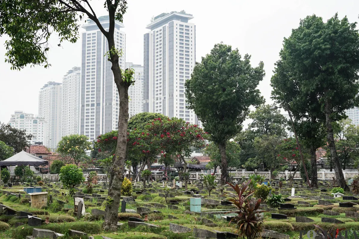 Petugas Suku Dinas Pertamanan dan Hutan Jakarta Selatan membersihkan salah satu makam di Tempat Pemakaman Umum (TPU) Grogol Selatan, Jakarta, Selasa, 21 Oktober 2025. (Sumber: Poskota/Bilal Nugraha Ginanjar)