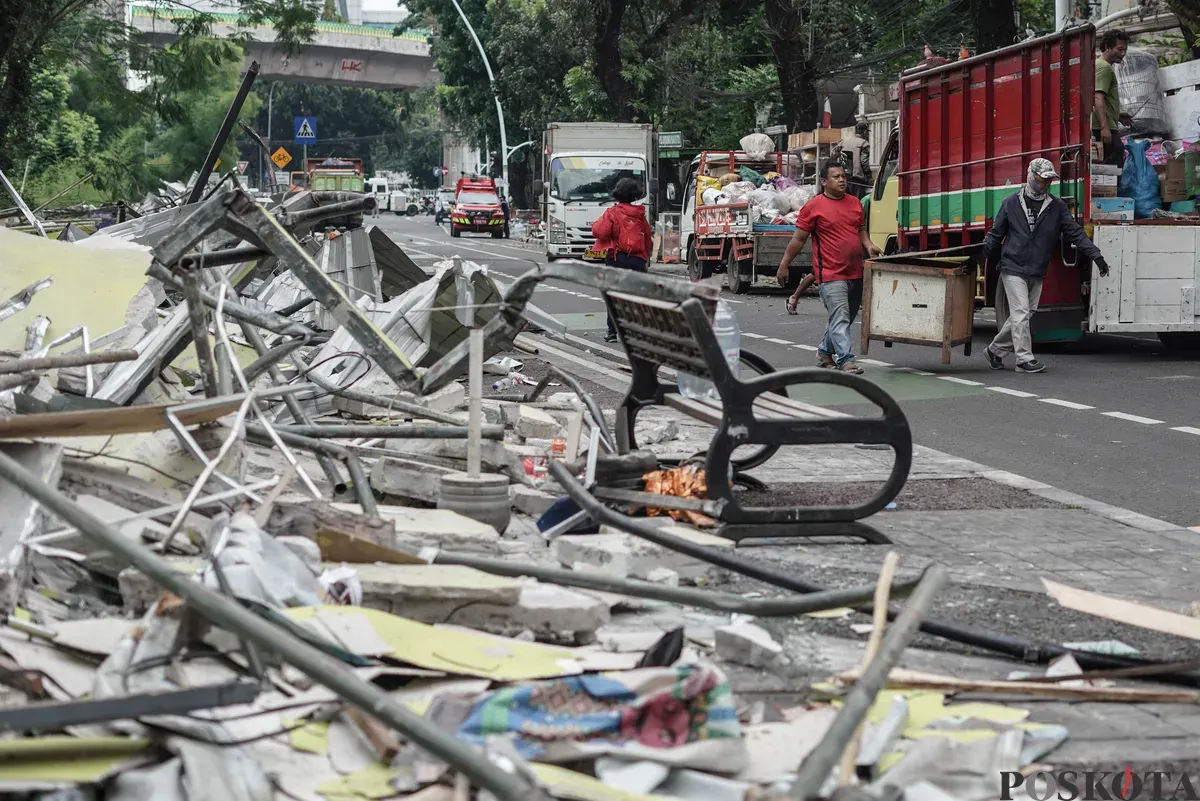 Petugas mengangkut puing-puing saat penertiban kios di Pasar Barito, Jakarta Selatan, Senin, 27 Oktober 2025. (Sumber: Poskota/Bilal Nugraha Ginanjar)