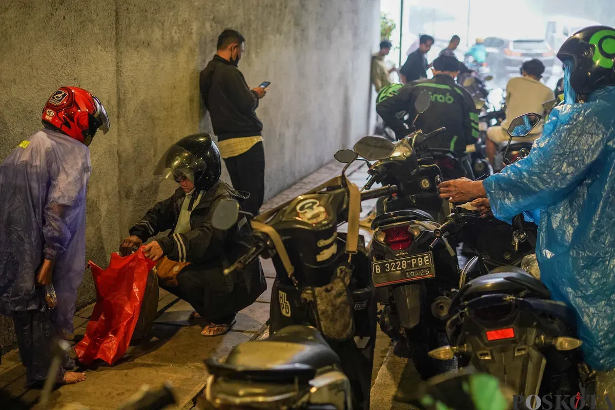 Sejumlah pengendara sepeda motor berteduh saat hujan di Terowongan Jalan R.M Margono Djojohadikoesoemo, Jakarta, Selasa, 9 September 2025. (Sumber: Poskota/Bilal Nugraha Ginanjar)