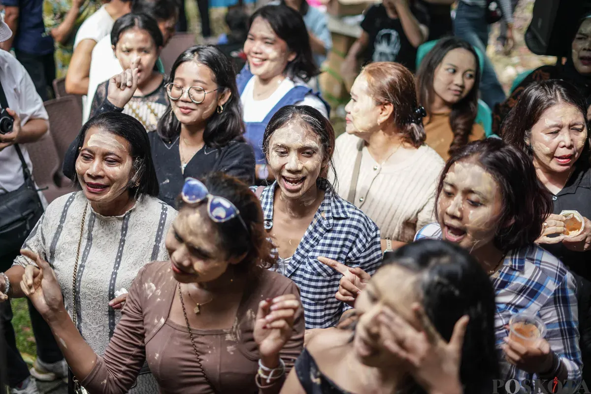 Orang Tugu menari sembari saling mencorengkan bedak saat mengikuti acara adat dan budaya Mandi-mandi di Kampung Tugu, Cilincing, Jakarta, Minggu, 4 Januari 2026. (Sumber: Poskota/Bilal Nugraha Ginanjar)