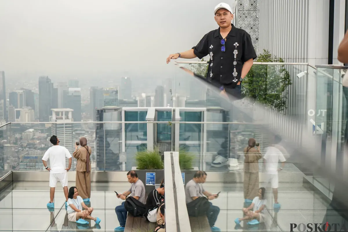 Warga berfoto diatap Gedung Thamrin Nine, Jakarta, Rabu, 11 Maret 2026. (Sumber: Poskota/Bilal Nugraha Ginanjar)