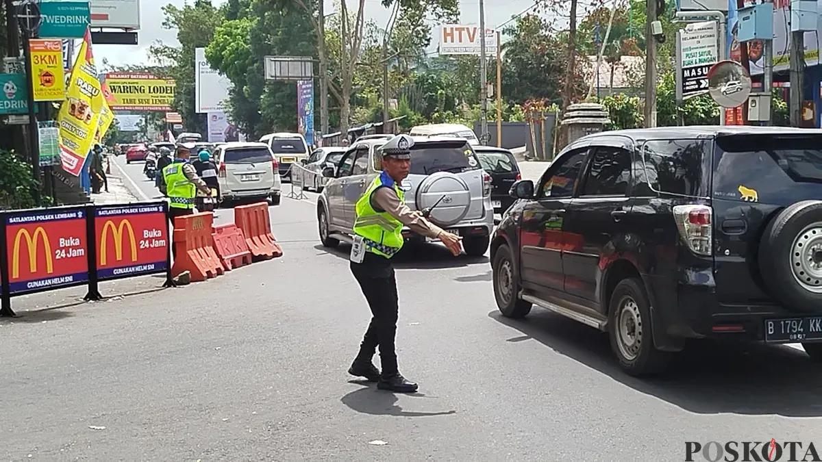 Anggota Satlantas Polres Cimahi melakukan oengaturan lalu lintas di Persimpangan Beatrix Lembang, Kabupaten Bandung Barat, Kamis 3 April 2025. (Sumber: Poskota/Gatot Poedji Utomo)