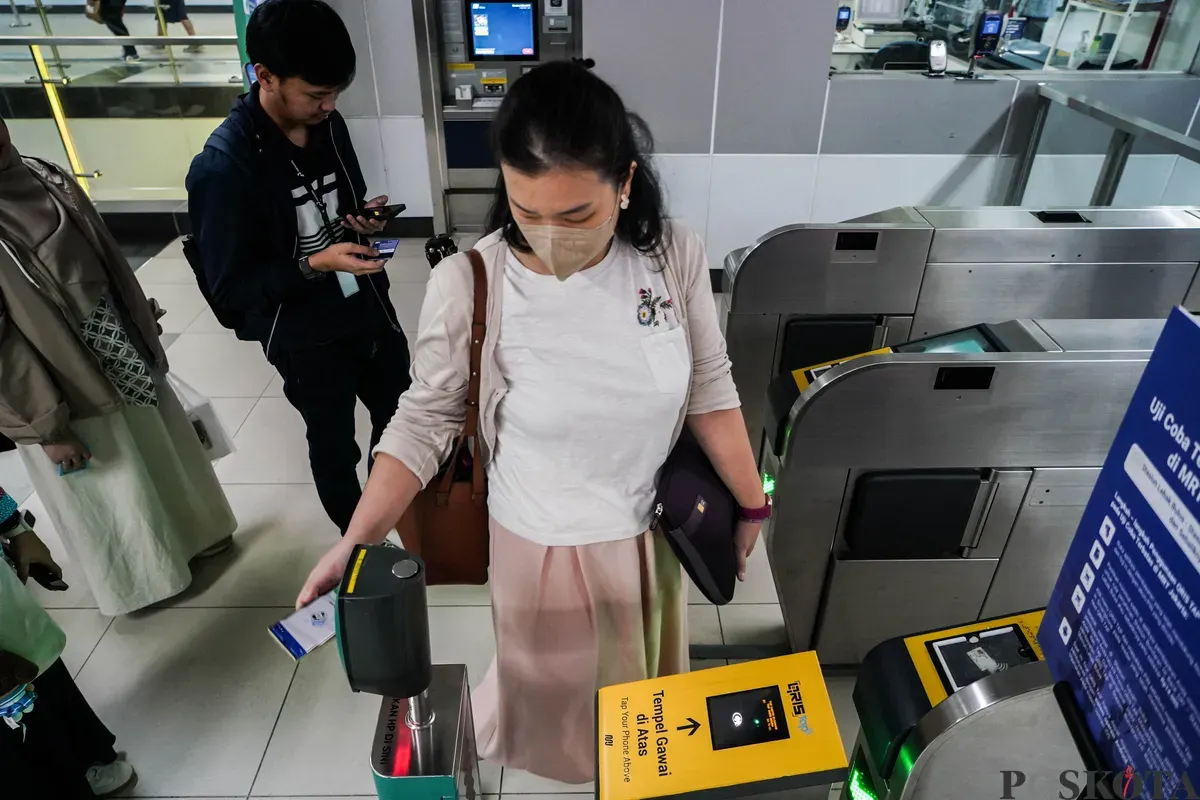 Calon penumpang menempelkan ponsel ke mesin pemindai untuk membayar kereta Moda Raya Terpadu (MRT). Khusus Hari Kartini pada Senin 21 April 2025, pemerintah memberikan tarif Rp1 untuk setiap penumpang wanita. (Sumber: Poskota/Bilal Nugraha Ginanjar)