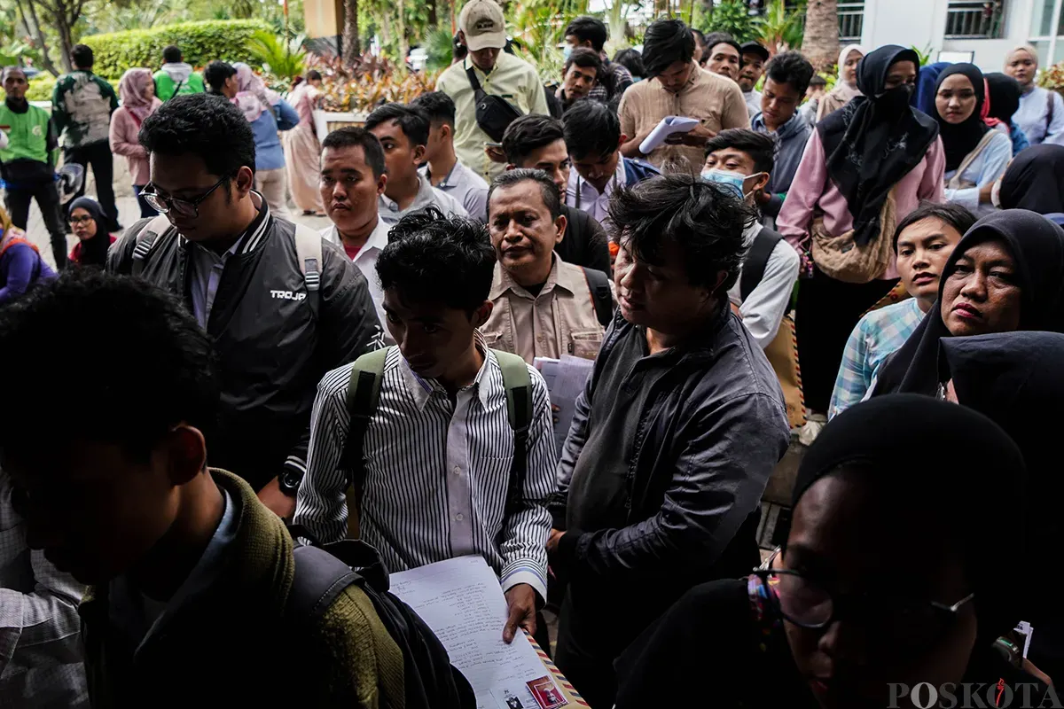 Warga memadati loket penerimaan surat dan barang sambil membawa amplop lamaran pekerjaan saat melamar kerja sebagai petugas di Penyedia Jasa Lainnya Perorangan (PJLP) di Balai Kota, Jakarta, Rabu, 23 April 2025. (Sumber: Poskota/Bilal Nugraha Ginanjar)