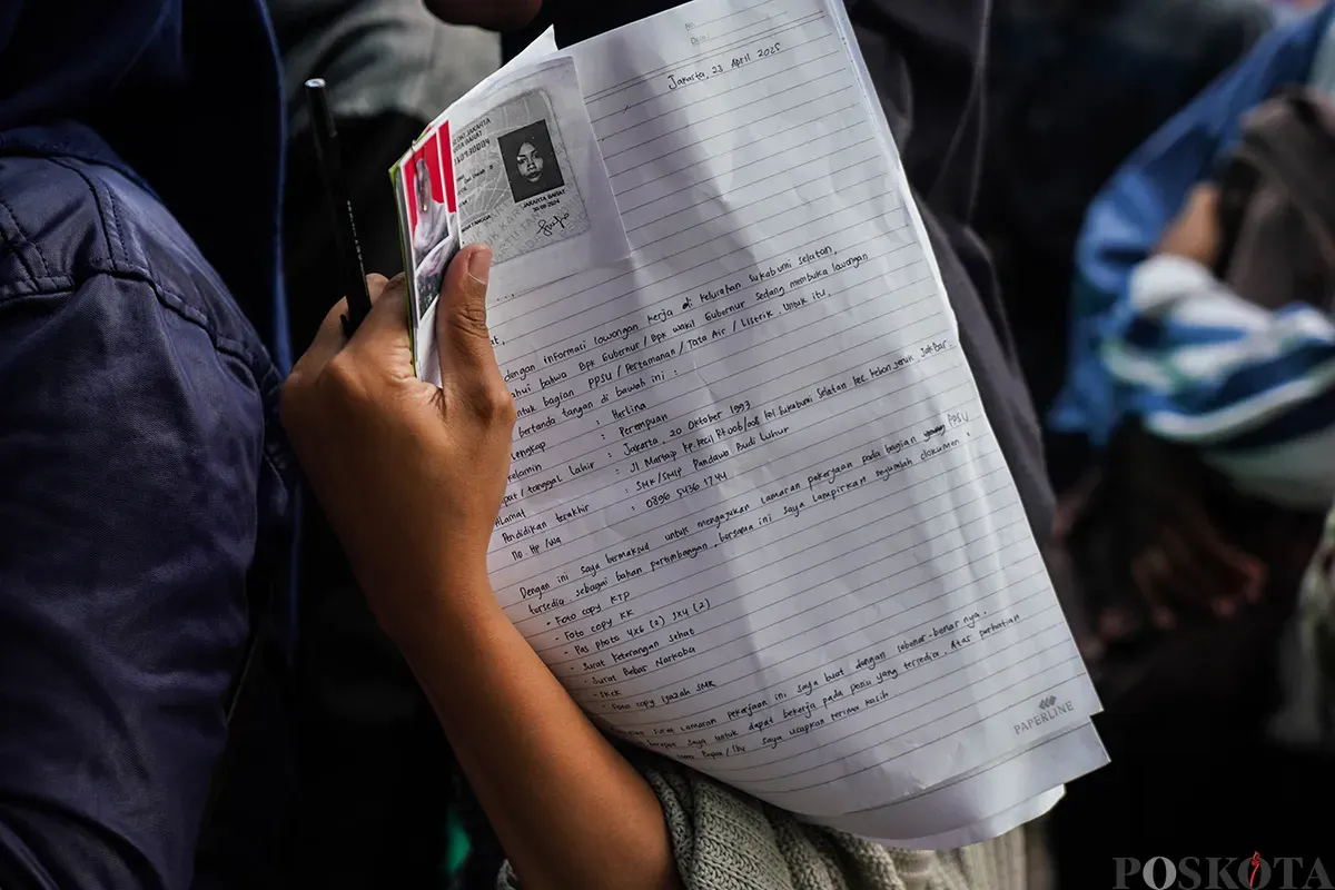 Warga memadati loket penerimaan surat dan barang sambil membawa amplop lamaran pekerjaan saat melamar kerja sebagai petugas di Penyedia Jasa Lainnya Perorangan (PJLP) di Balai Kota, Jakarta, Rabu, 23 April 2025. (Sumber: Poskota/Bilal Nugraha Ginanjar)