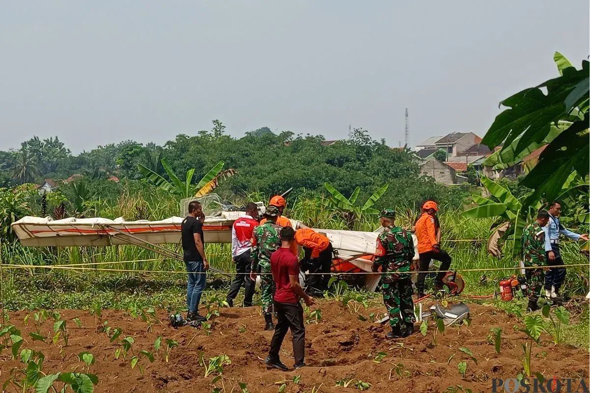 Pesawat latih terjatuh di TPU Kampung Astana, Desa Benteng, Kecamatan Ciampea, Kabupaten Bogor, Minggu, 3 Agustus 2025. (Sumber: Poskota/Giffar Rivana)