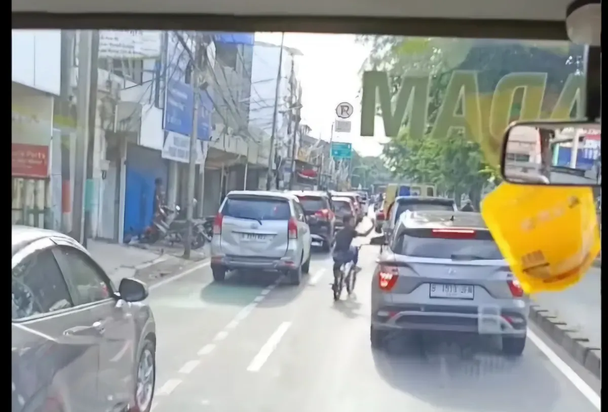 Sambil gowes sepeda, bocah ini bantu damkar buka jalan. (Sumber: Instagram/@damkarjatim)
