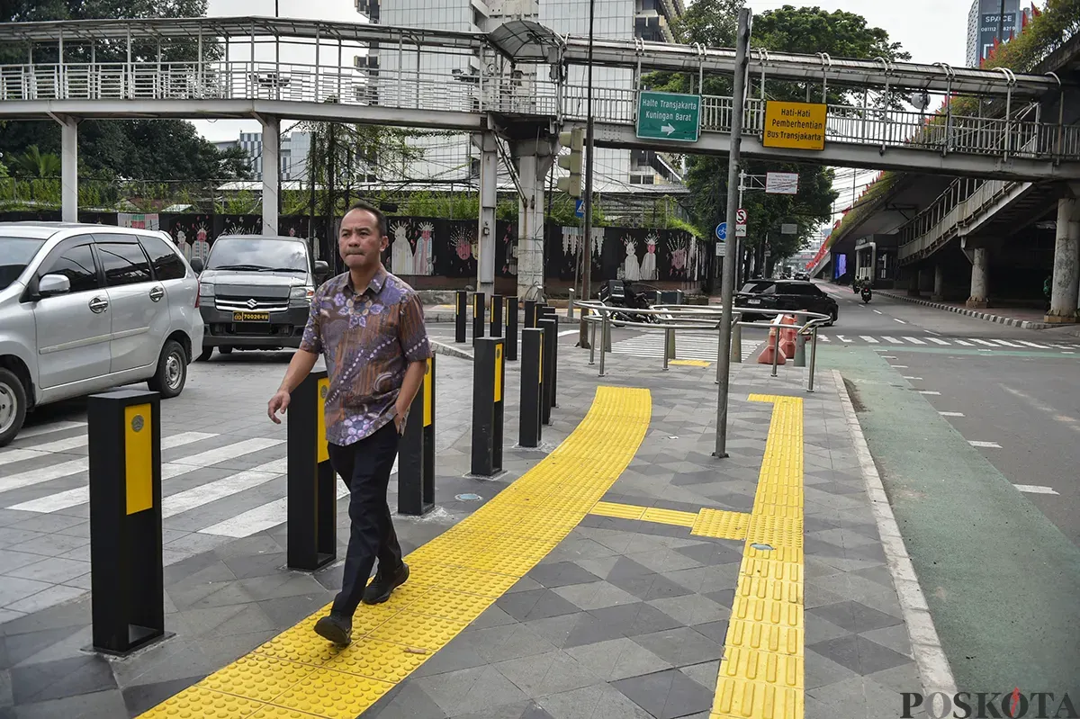 Warga melintas di trotoar Jalan Rasuna Said, Jakarta Selatan, Jumat, 10 Januari 2025. (Sumber: Poskota/ Bilal Nugraha Ginanjar)