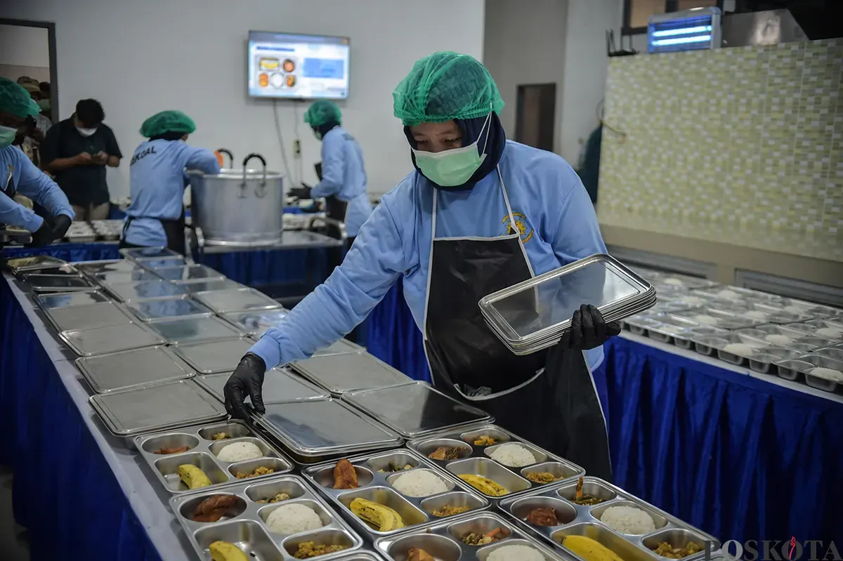Pekerja menyiapkan paket makanan yang akan didistribusikan pada program Makan Bergizi Gratis (MBG). (Sumber: Poskota/ Bilal Nugraha Ginanjar)