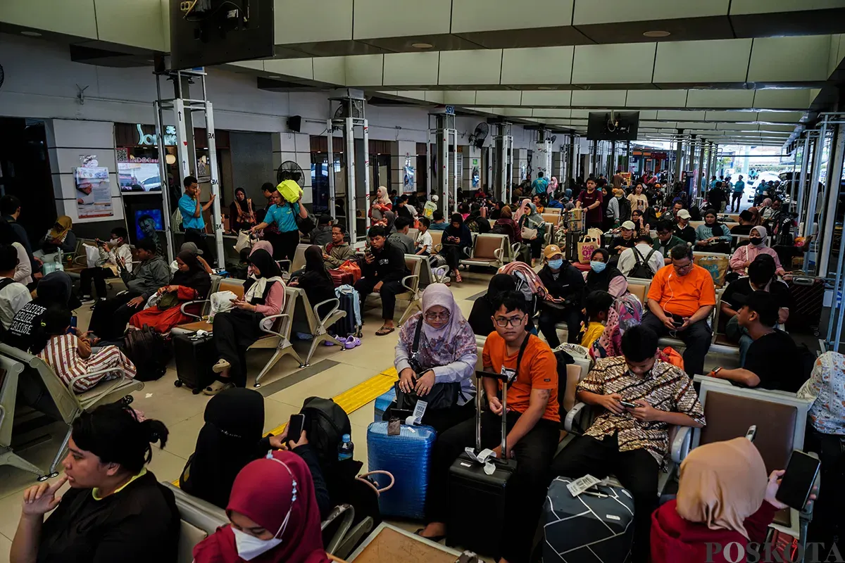 Antrean penumpang masuk ke dalam peron sambil membawa barang bawaannya di Stasiun Pasar Senen, Jakarta, Sabtu, 22 Maret 2025. (Sumber: Poskota/Bilal Nugraha Ginanjar)