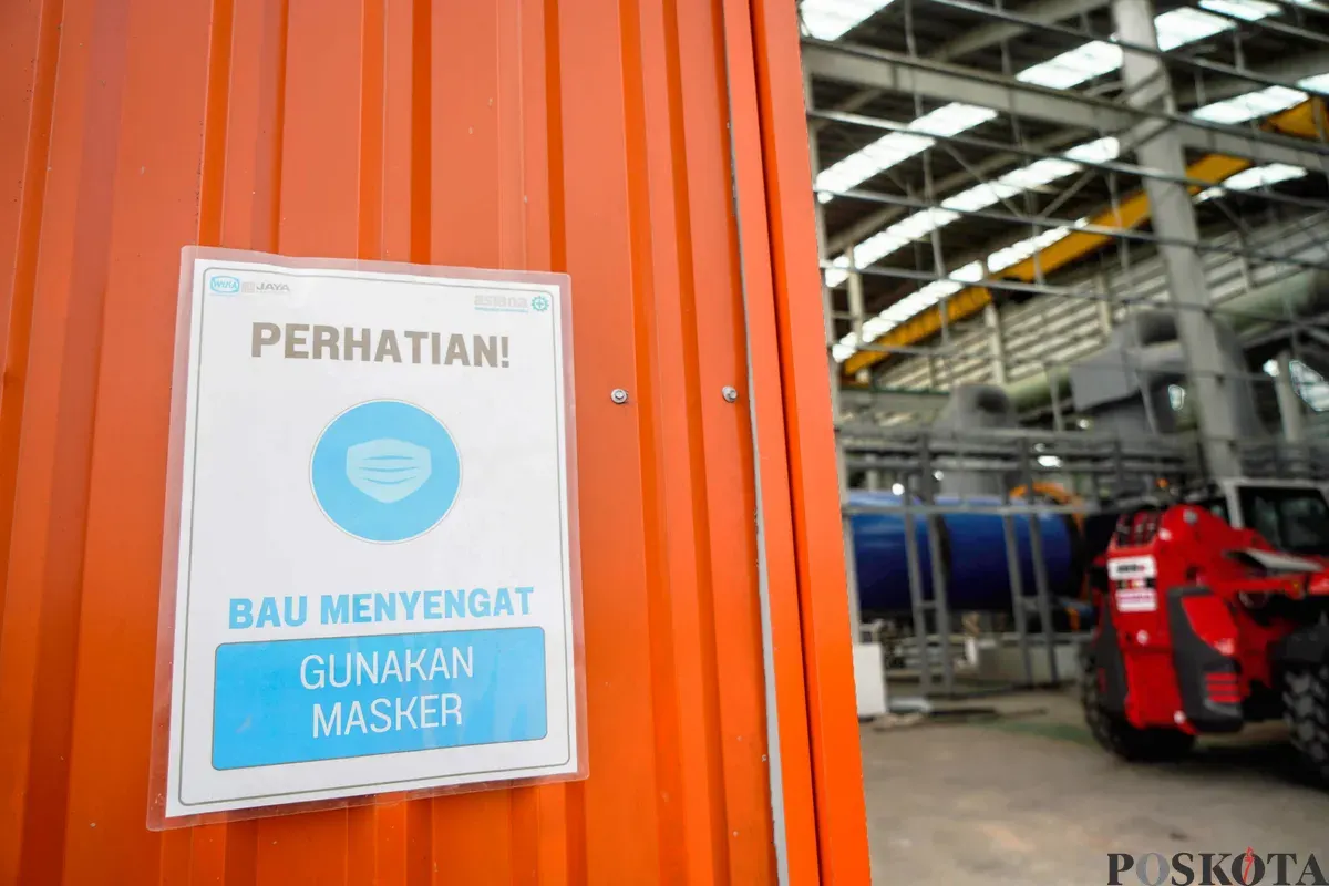 Pengumuman imbauan penggunaan masker terpasang di pintu masuk area gudang pengolahan sampah terpadu, Refuse Derived Fuel (RDF) Plant Rorotan, Jakarta Utara, Selasa, 25 Maret 2025. (Sumber: Poskota/Bilal Nugraha Ginanjar)