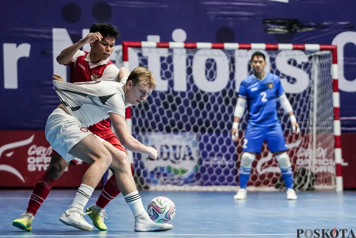 Pemain Timnas futsal Indonesia Ardiansyah Nur berebut bola dengan pemain Timnas futsal Latvia pada turnamen AQUA Futsal Four Nations Cup 2025 di GBK Basket Hall, Senayan, Jakarta, Minggu (21/9/2025). (Sumber: Poskota/Bilal Nugraha Ginanjar)
