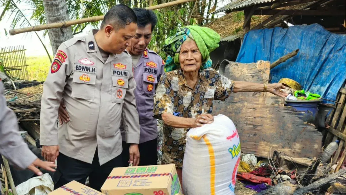 Petugas Polsek Ciruas memberikan bantuan sembako kepada korban kebakaran rumah di Kampung Kesampangan, Desa Cigelam, Kecamatan Ciruas, Kabupaten Serang. (Sumber: Dok. Istimewa)