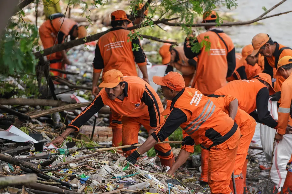 Petugas mengangkut sampah yang menumpuk di kawasan pesisir Marunda, Jakarta, Kamis, 12 Januari 2026. (Sumber: Poskota/Bilal Nugraha Ginanjar)