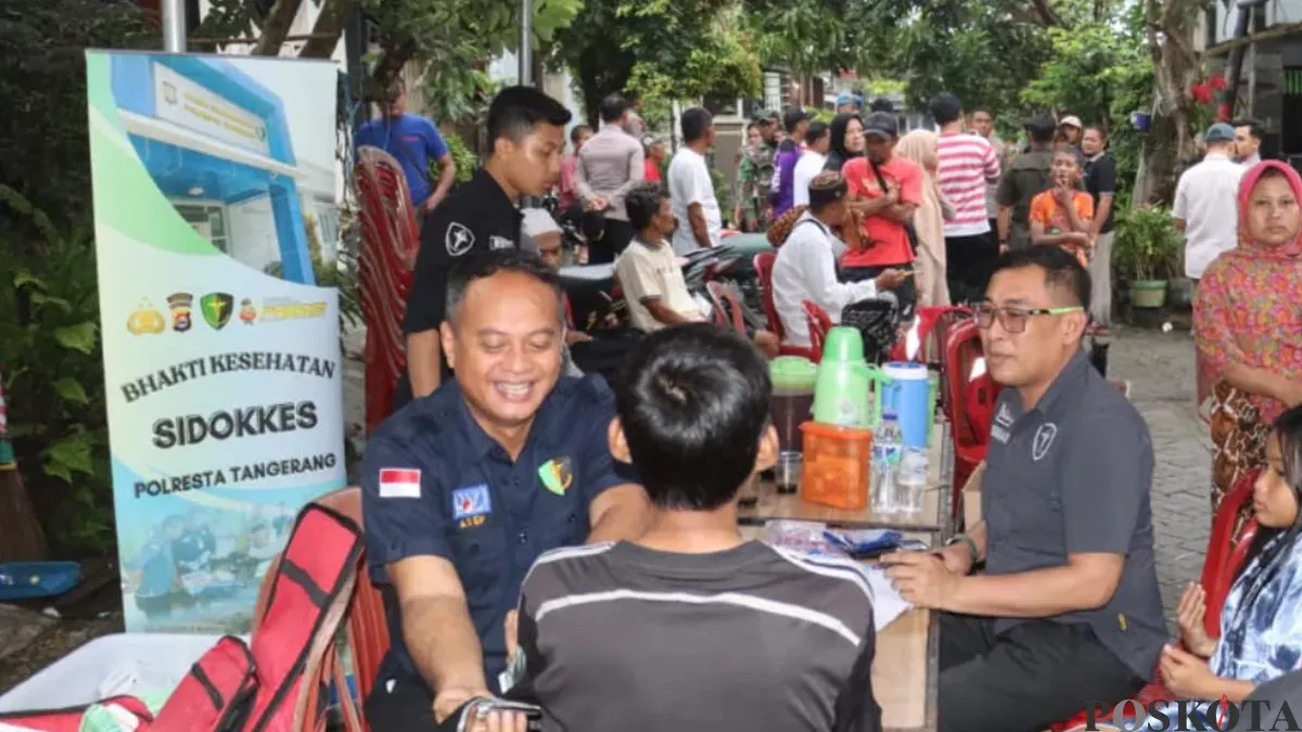 Tim medis Polresta Tangerang saat melakukan pemeriksaan kesehatan warga terdampak banjir. (Sumber: Poskota/Veronica)