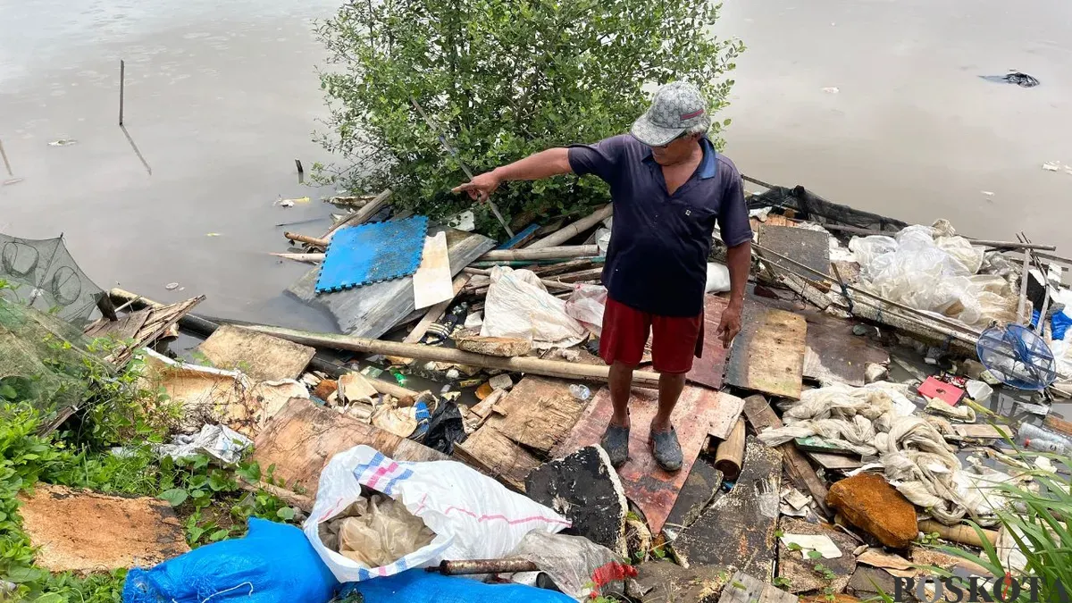 Warga menunjukan kawasan tanggul Muara Baru, Penjaringan, Jakarta Utara yang dipenuhi sampah, Sabtu, 17 Januari 2026. (Sumber: Poskota/Pandi Ramedhan)