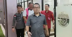 Penyidik Kejati Banten menggiring Kabid Persampahan DLHK Kota Tangsel, Tubagus Aprilliadhi Kusumah Perbangsah untuk ditahan di Rutan Kelas II B Pandeglang, Rabu, 16 April 2025. (Sumber: Poskota/Rahmat Haryono)