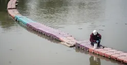 Petugas menyemprotkan air saat simulasi penanganan busa di Pintu Air Weir 3 Marunda, Kanal Banjir Timur (KBT), Jakarta Utara, Rabu, 13 Agustus 2025. (Sumber: Poskota/Bilal Nugraha Ginanjar)