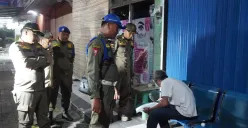 Petugas Satpol PP saat memberikan surat edaran tentang jam operasional usaha di Kabupaten Tangerang selama bulan Ramadhan. (Sumber: Poskota/Veronica Prasetio)