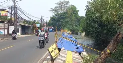 Kondisi trotoar di Jalan Raya Sawangan, Kecamatan Pancoran Mas, Kota Depok, Jawa Barat, ambles ke tepi saluran air, Senin, 28 September 2026. (Sumber: Poskota/Sabda Maulana)