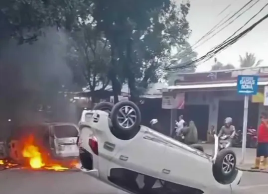 Mobil petugas Polres Metro Depok dibakar massa  saat akam membawa mengamankan seorang pelaku kejahatan di Cimanggis, Kota Depok, Jumat, 18 April 2025. (Sumber: Damkar Depok)