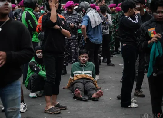 Seorang massa aksi terlihat kelelahan dalam demonstrasi di depan Satuan Brimob Polda Metro Jaya, Kecamatan Senen, Jakarta Pusat, Jumat, 29 Agustus 2025. (Sumber: Poskota/Bilal Nugraha Ginanjar)