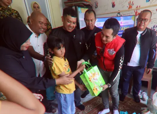 Kajari Kabupaten Bogor, Denny Achmad menyalurkan sembako kepada siswa berkebutuhan khusus di sekolah Jendela Ibu, Kecamatan Ciawi, Jumat, 12 Desember 2025. (Sumber: Poskota/Giffar Rivana)