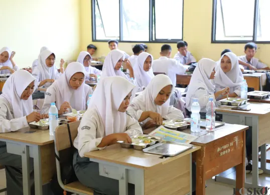 Siswa-siswi di SMAN 1 Pebayuran, Kabupaten Bekasi, saat menyantap program makan bergizi gratis (MBG), Senin, 1 Januari 2025. (Sumber: Poskota/Ihsan)