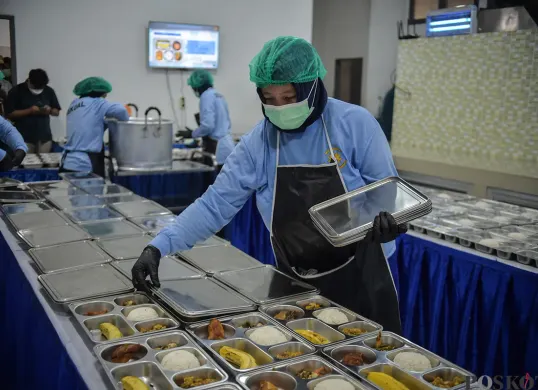 Pekerja menyiapkan paket makanan yang akan didistribusikan pada program Makan Bergizi Gratis (MBG). (Sumber: Poskota/ Bilal Nugraha Ginanjar)