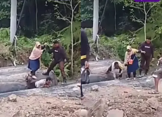 Momen anggota polisi menjadikan punggungnya sebagai jembatan untuk membantu warga menyebrang. (Sumber: Tangkap Layar Instagram/@funnelmedia)