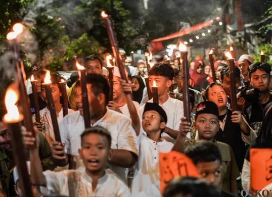 Sejumlah warga mengikuti pawai obor di kawasan Menteng, Jakarta, Kamis, 26 Juni 2025, lalu. Pawai obor tersebut diikuti oleh warga Menteng RW 08. (Sumber: Poskota/Bilal Nugraha Ginanjar)