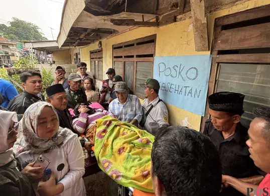 Warga mengevakuasi korban luka akibat bangunan majelis taklim yang ambruk di Kampung Ciapus, Kecamatan Ciomas, Kabupaten Bogor pada Minggu pagi, 7 September 2025. (Sumber: POSKOTA | Foto: Giffar Rivana)