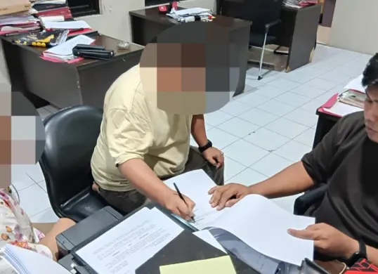 Pasutri RH dan RM saat menjalani pemeriksaan di ruang Unit Reskrim Polsek Cikande atas dugaan kasus penipuan pencari kerja. (Sumber: Polsek Cikande)