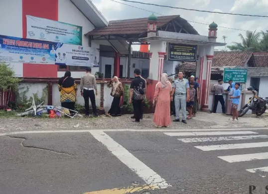 Sejumlah anggota Polisi saat melakukan olah TKP laka lantas di depan SD Negeri Sukaratu 5 Pandeglang. (Sumber: Poskota/Samsul Fatoni)