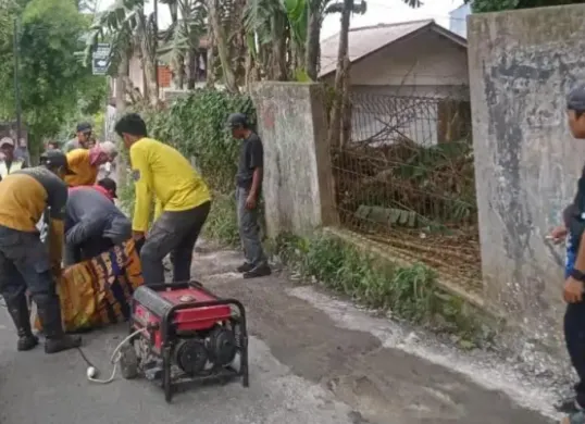 Petugas DPUPR Kota Depok memperbaiki jalan yang amblas di Jalan Manggis RT 01 RW 13, Kelurahan Rangkapan Jaya Baru, Kecamatan Pancoran Mas, Kota Depok. (Sumber: DPUPR Kota Depok)