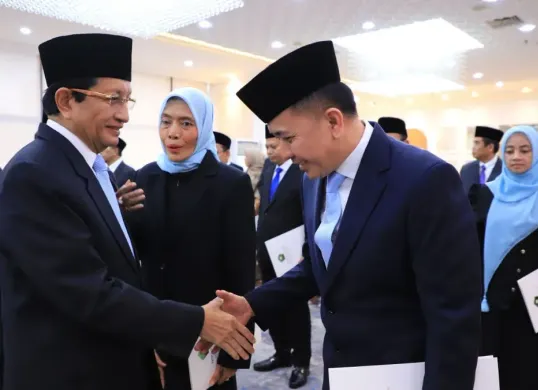 Menag Nasaruddin Umar menyerahkan Keppres Penetapan Anggota BAZNAS kepada Dirjen Bina Keuda Agus Fatoni. (Sumber: Dok. Puspen Kemendagri)