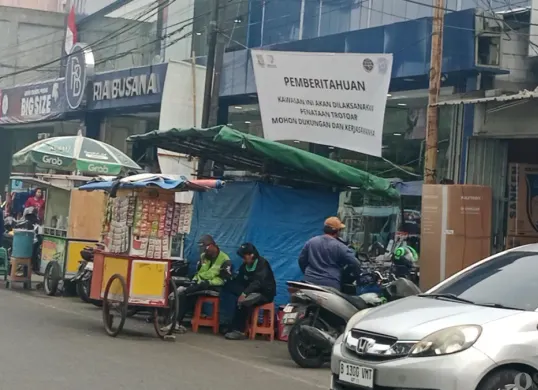 Pemberitahuan rencana penataan trotoar yang terpasang di depan pertokoan kawasan Stasiun Tangerang, Senin, 12 Oktober 2026. (Sumber: Poskota/Rizki Gojali)